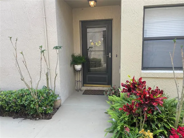 a vase with flowers sitting on a floor