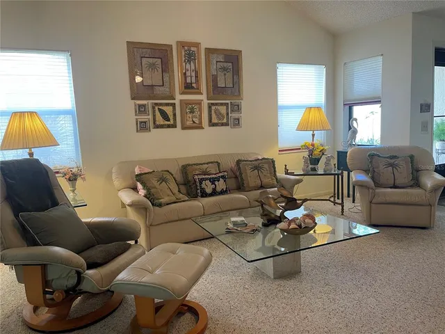 a living room with furniture a lamp and a window
