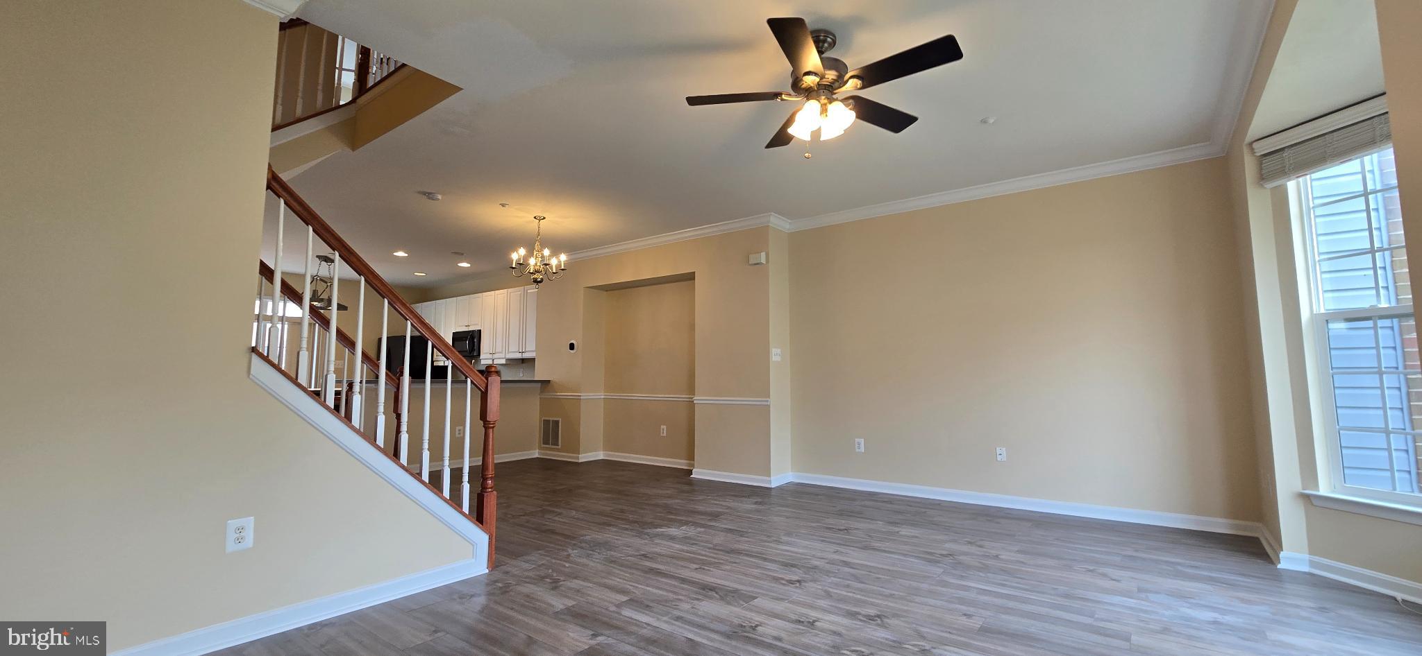 2630 Raptor Drive Odenton, MD 21113 - Photo 5 of 38 a view of a hallway with wooden floor and a chandelier fan