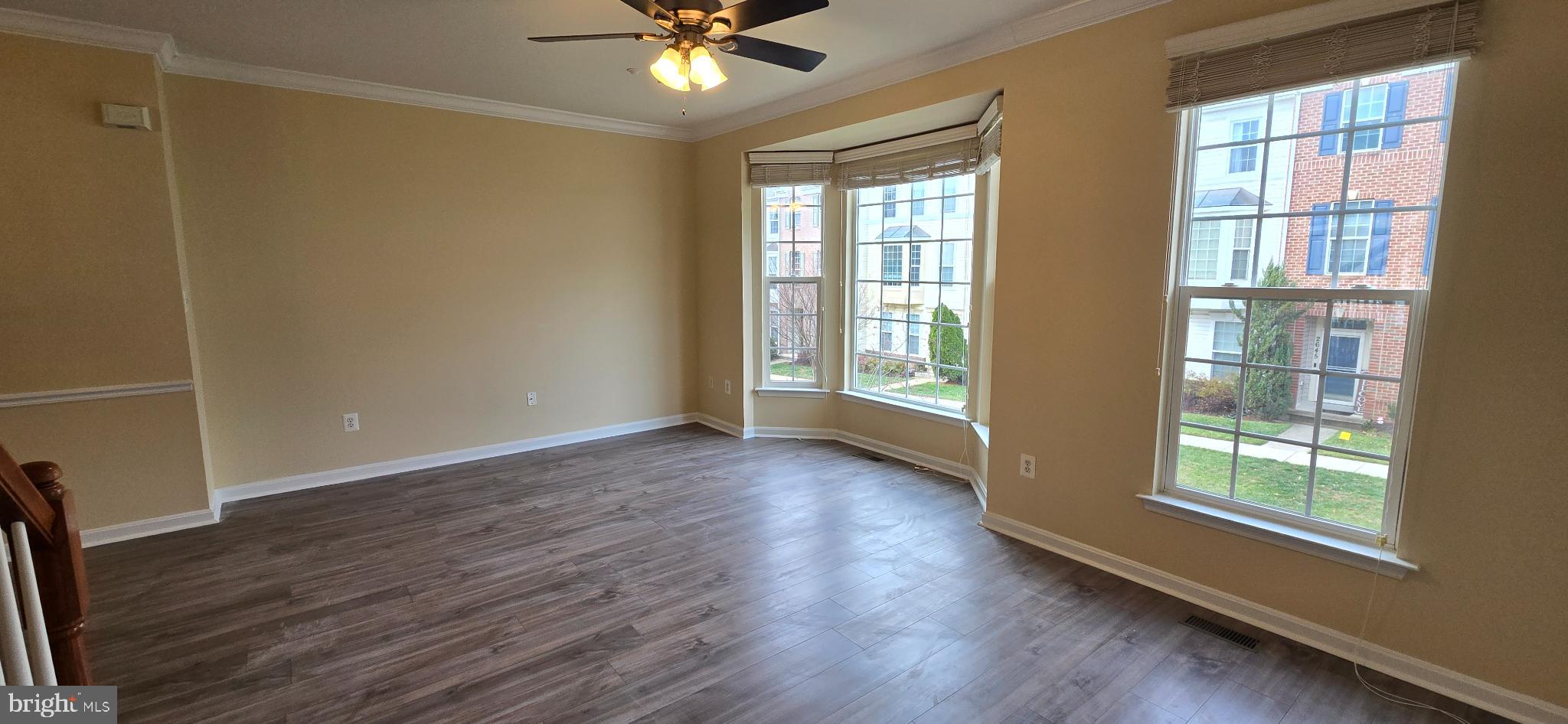 2630 Raptor Drive Odenton, MD 21113 - Photo 6 of 38 an empty room with wooden floor fan and windows