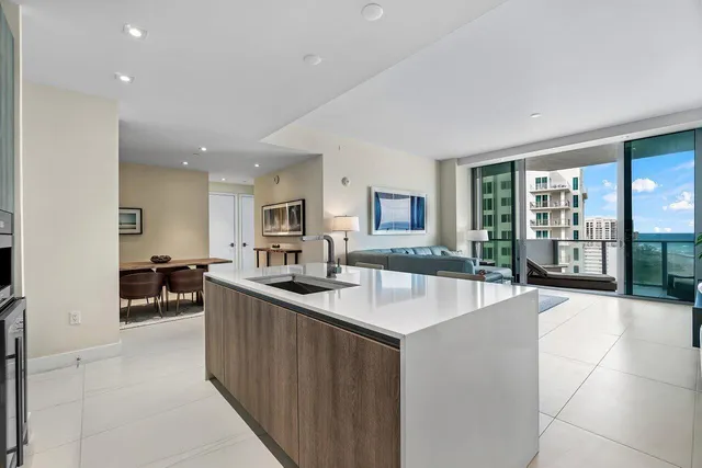 a large kitchen with kitchen island a sink stainless steel appliances and cabinets