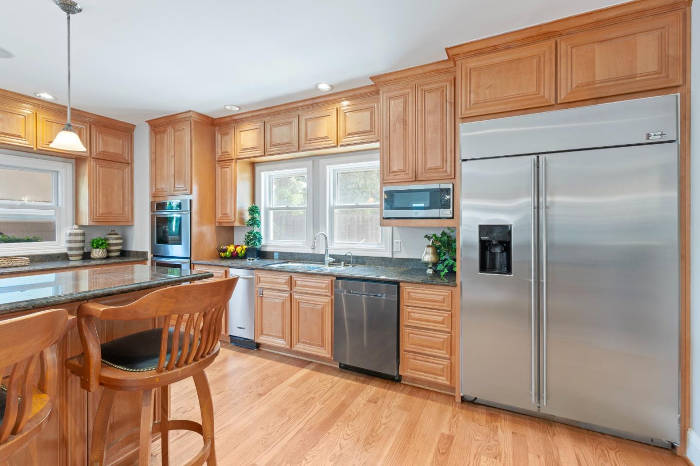 976 Riverside Drive San Jose, CA 95125 - Photo 20 of 78 a kitchen with stainless steel appliances granite countertop a refrigerator a stove a sink and white cabinets with wooden floor