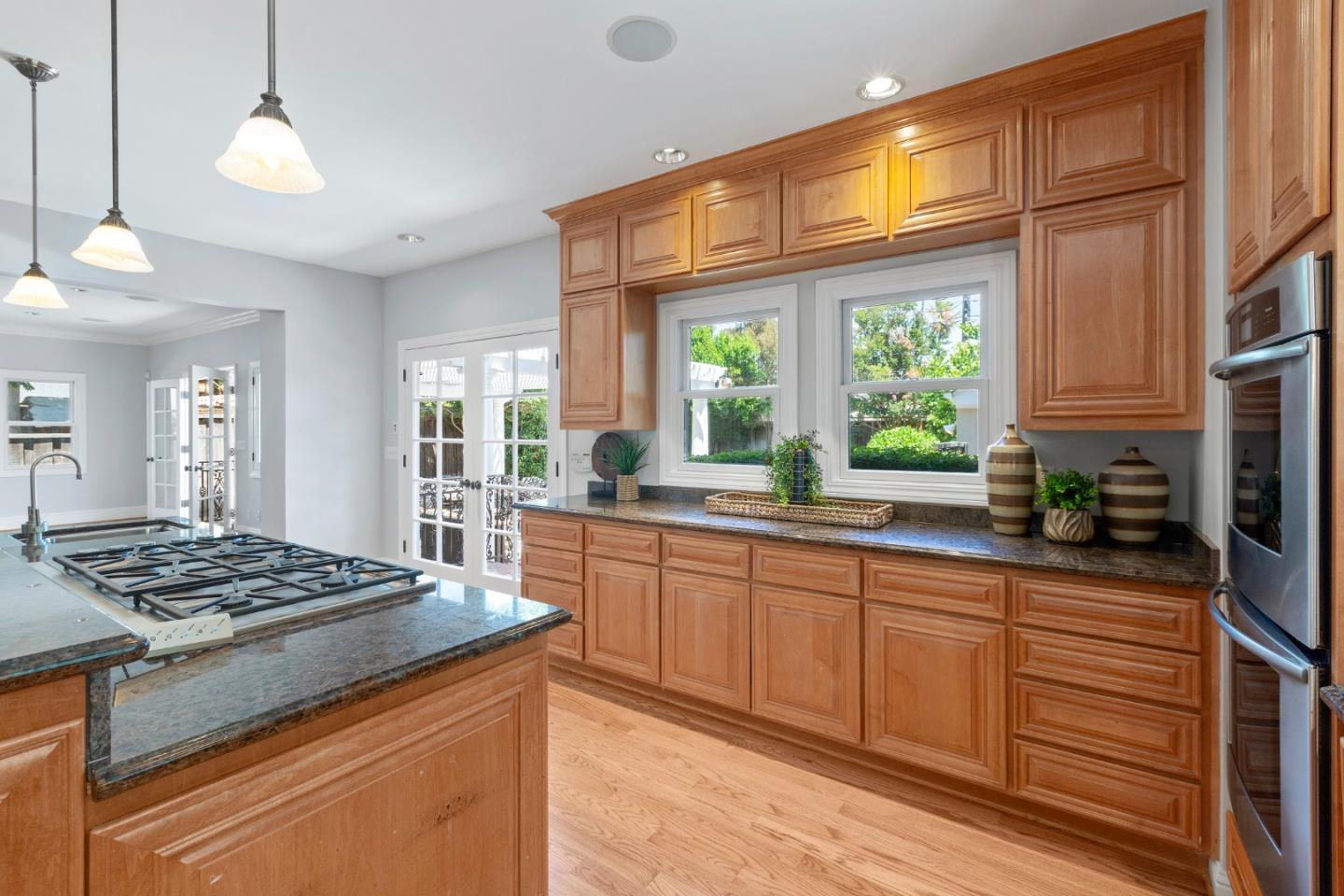 976 Riverside Drive San Jose, CA 95125 - Photo 23 of 78 a kitchen with stainless steel appliances granite countertop a stove a sink dishwasher and cabinets with wooden floor