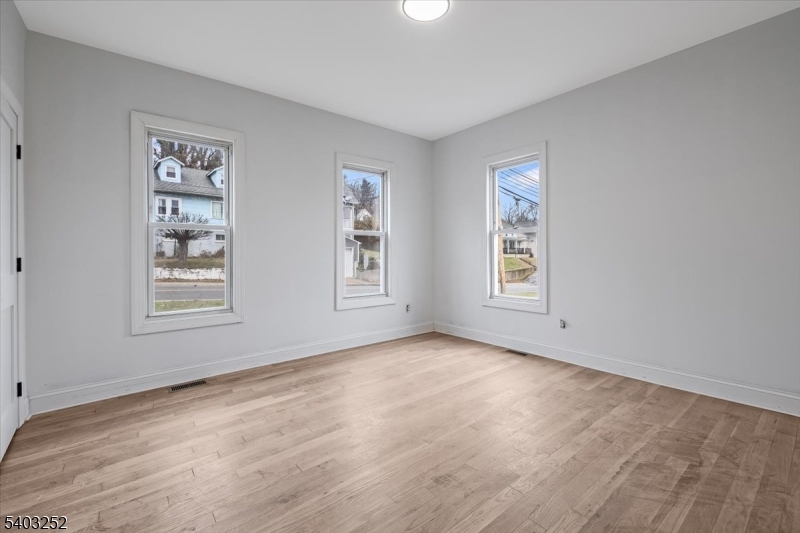 120 High Street, Unit 2 Newton, NJ 07860 - Photo 3 of 7 a view of an empty room with window and wooden floor