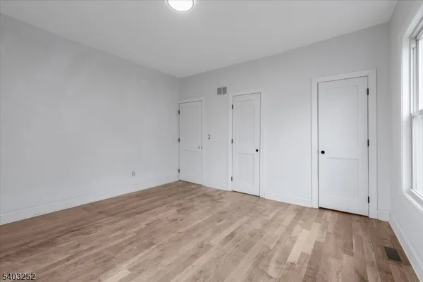 a view of an empty room and wooden floor