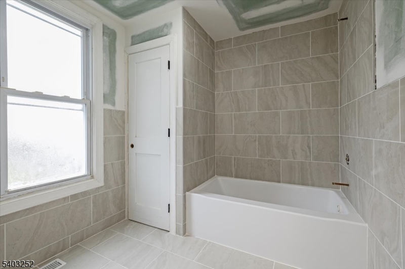 120 High Street, Unit 2 Newton, NJ 07860 - Photo 5 of 7 a bathroom with a bathtub and window