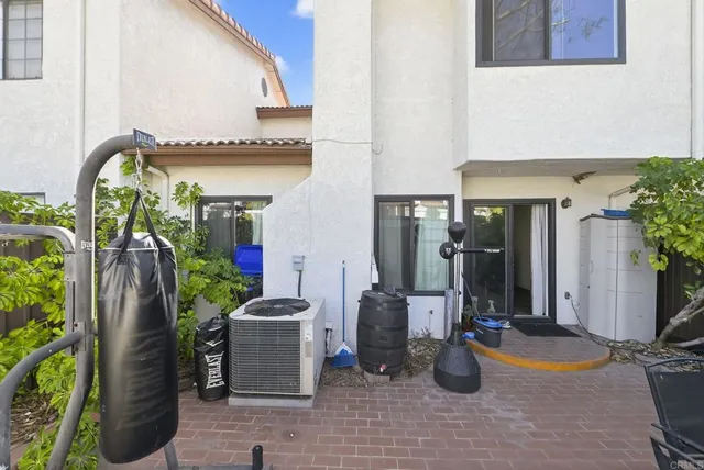 a view of a patio with plants and chairs and potted plants