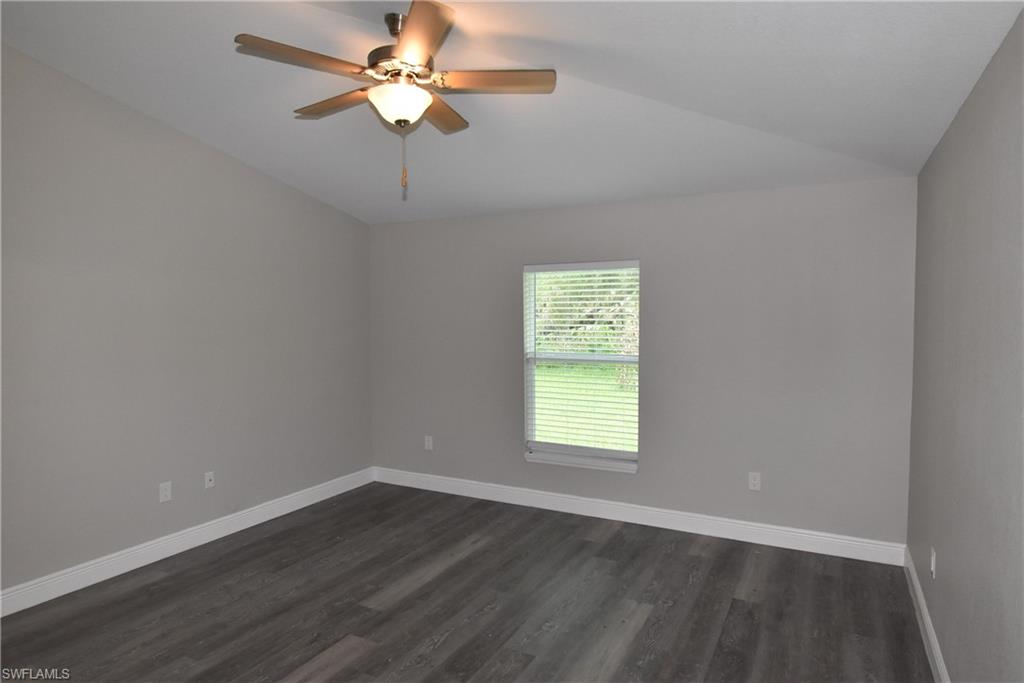 2140 Yalta Terrace North Port, FL 34286 - Photo 15 of 26 Unfurnished room featuring a ceiling fan, dark wood-type flooring, and lofted ceiling