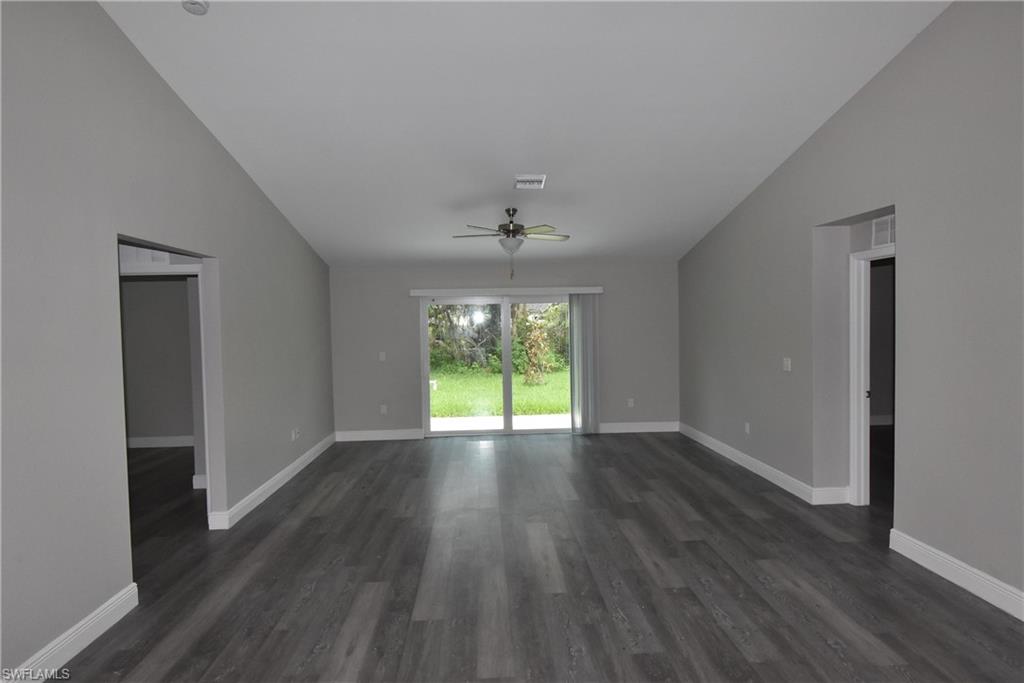 2140 Yalta Terrace North Port, FL 34286 - Photo 6 of 26 Empty room with vaulted ceiling, a ceiling fan, and dark wood-style flooring