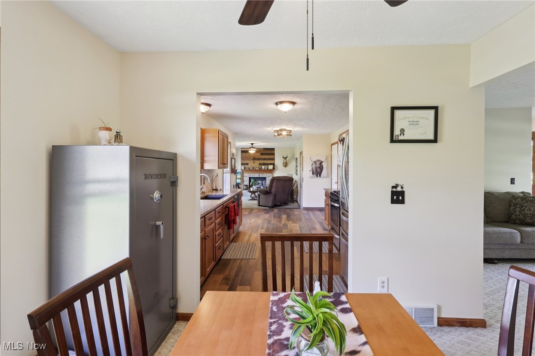41553 Parsons Road Lagrange, OH 44050 - Photo 21 of 50 Dining space featuring a ceiling fan, dark wood-style floors, healthy amount of natural light, and baseboards