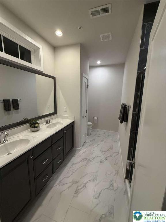 6907 Cedar Drive Bath, PA 18014 - Photo 14 of 23 a bathroom with a double vanity sink and mirror