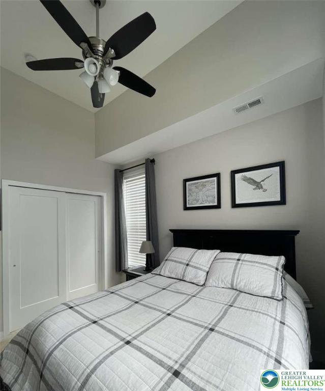 6907 Cedar Drive Bath, PA 18014 - Photo 5 of 23 a bedroom with a large bed and a chandelier