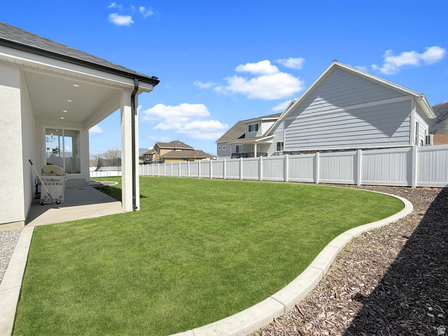 916 Rocky Mountain Way Elk Ridge, UT 84651 - Photo 49 of 54 Fenced backyard with a patio area and a residential view