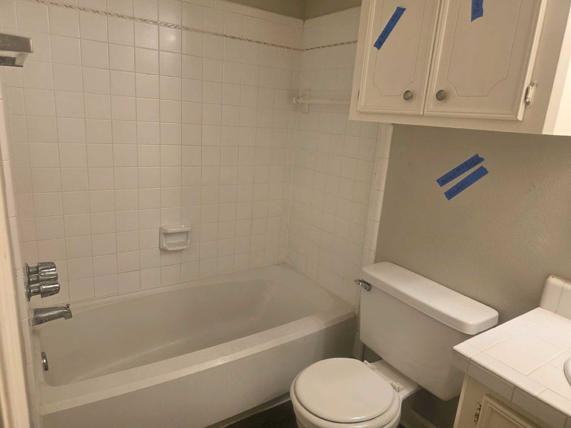 5006 Timber Ridge Street Baytown, TX 77521 - Photo 4 of 6 a white toilet and tub sitting next to a window