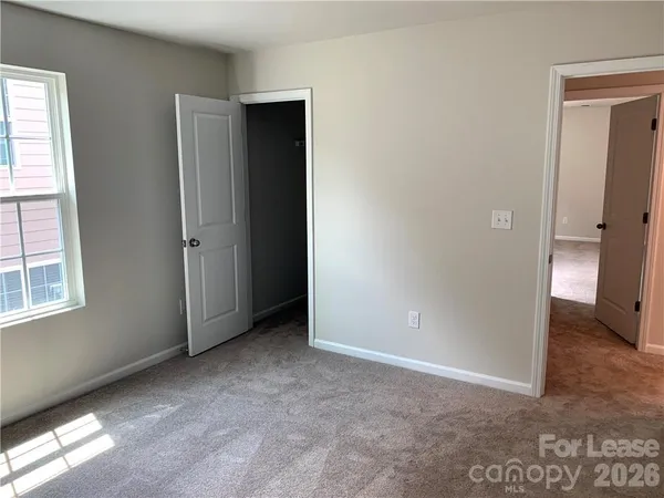 an empty room with windows and closet