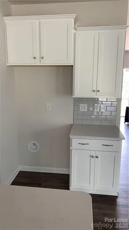 a view of a kitchen with granite countertop cabinets