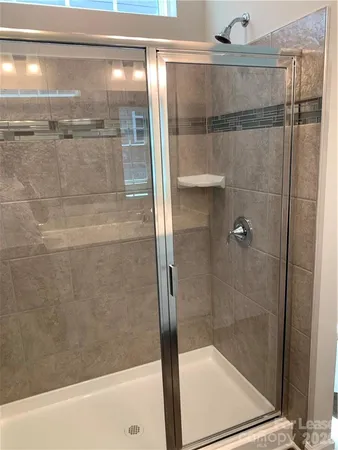 a bathroom with a glass shower door