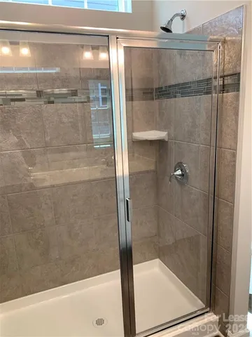 a bathroom with a glass shower door