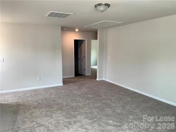 an empty room with closet and a projector screen