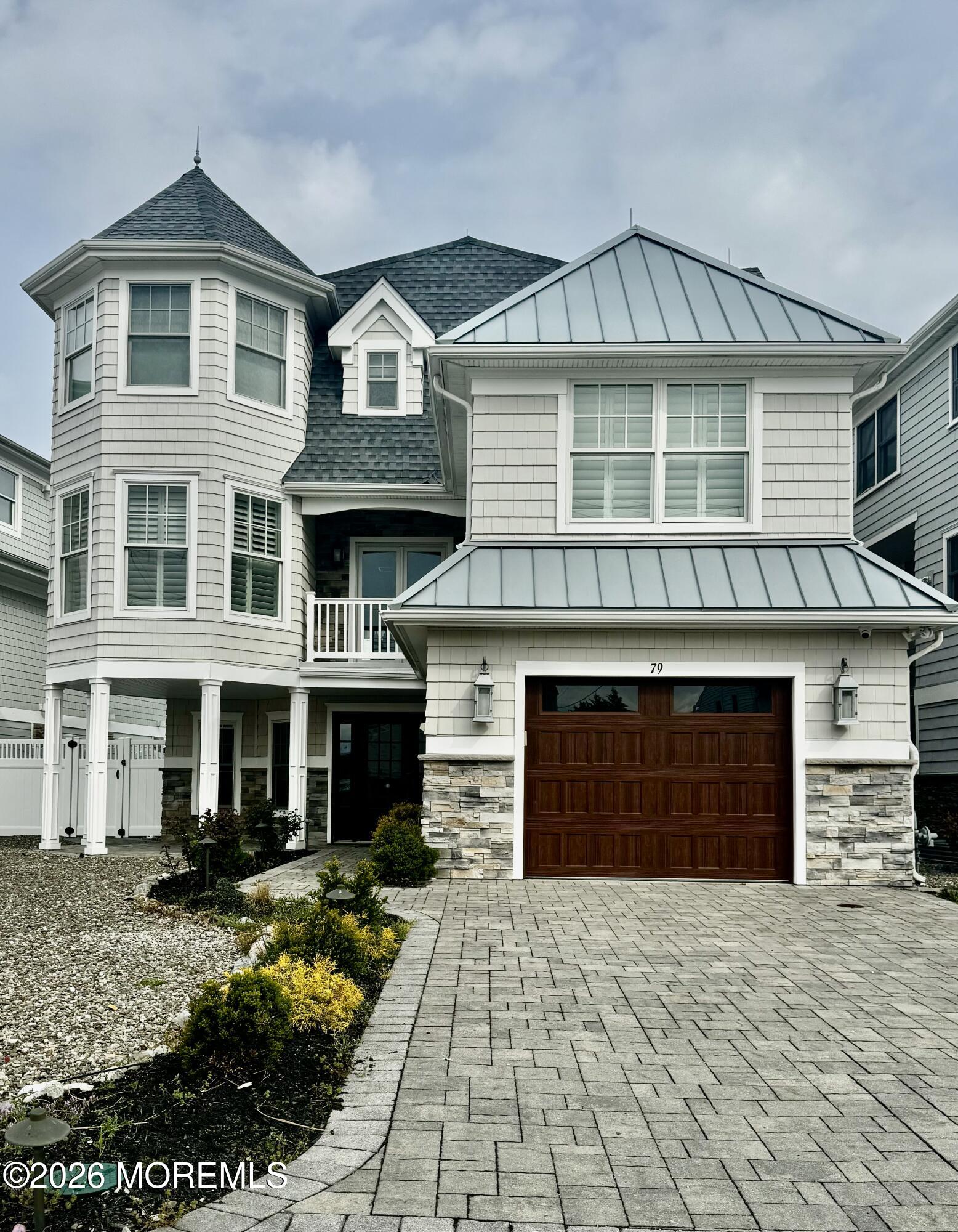 79 Pershing Boulevard Lavallette, NJ 08735 - Photo 1 of 11 a front view of a house with a yard and garage