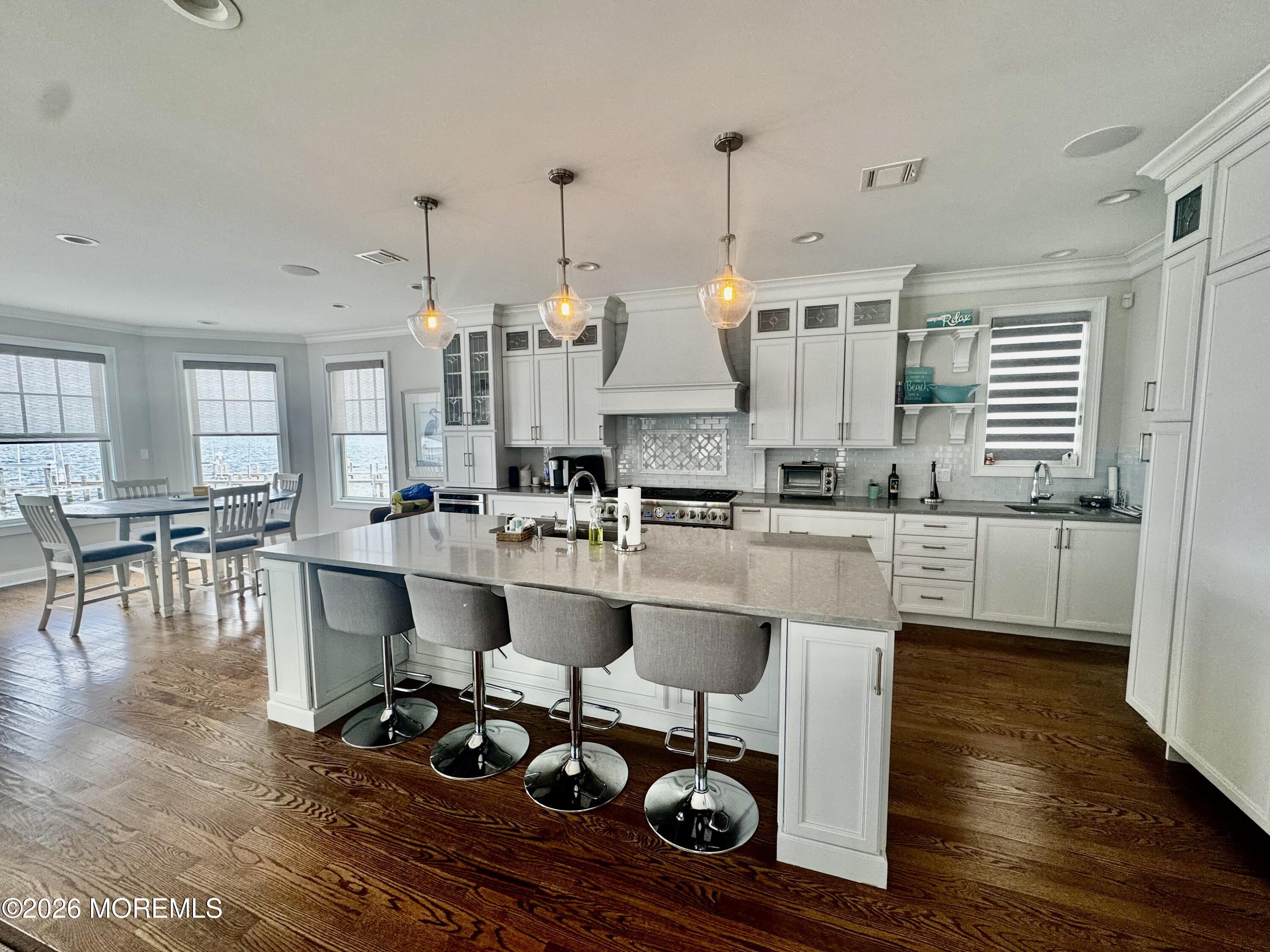 79 Pershing Boulevard Lavallette, NJ 08735 - Photo 2 of 11 a large kitchen with stainless steel appliances kitchen island granite countertop a stove a sink and white cabinets