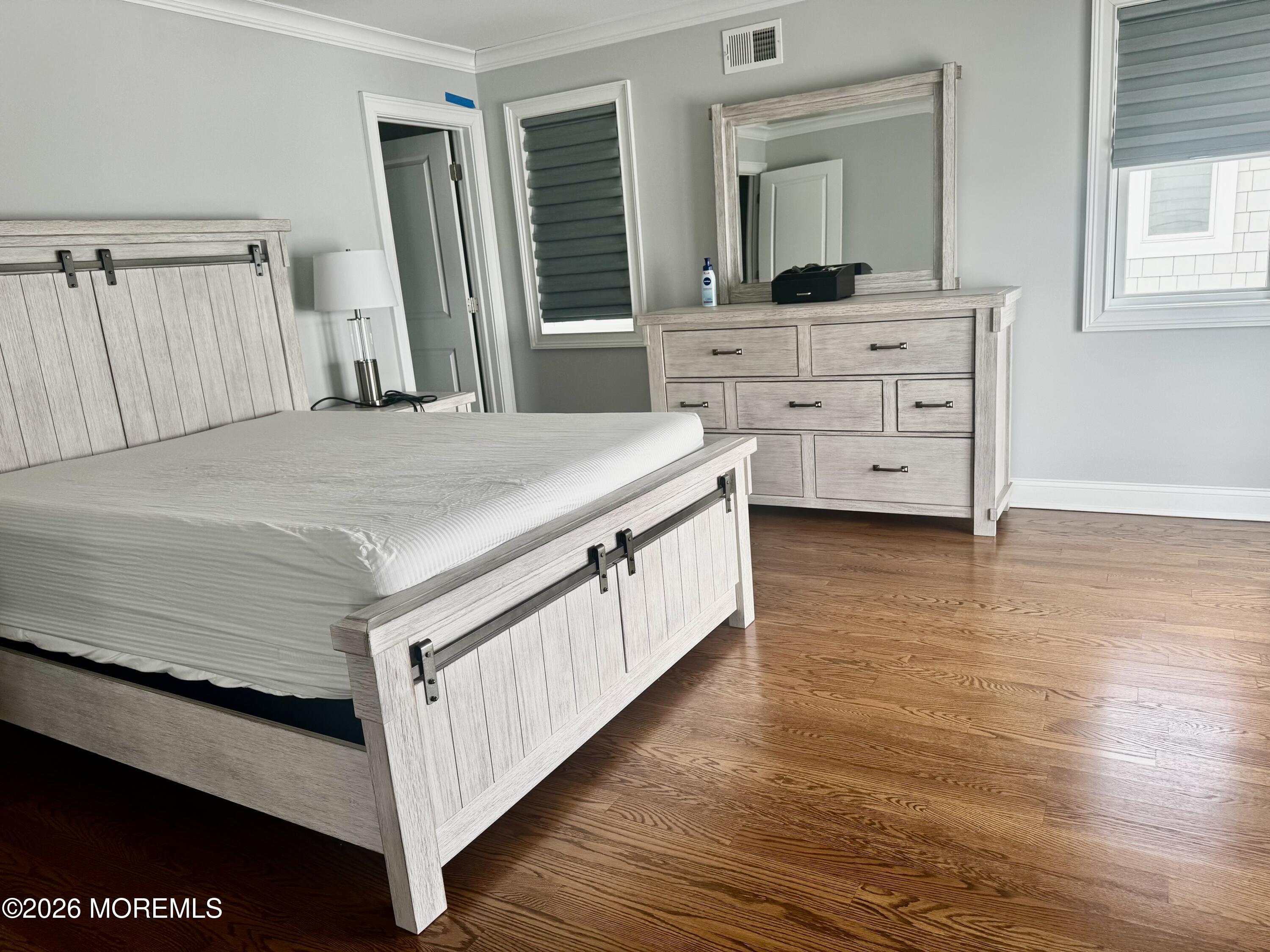 79 Pershing Boulevard Lavallette, NJ 08735 - Photo 5 of 11 a room with a bed and a mirror on dresser
