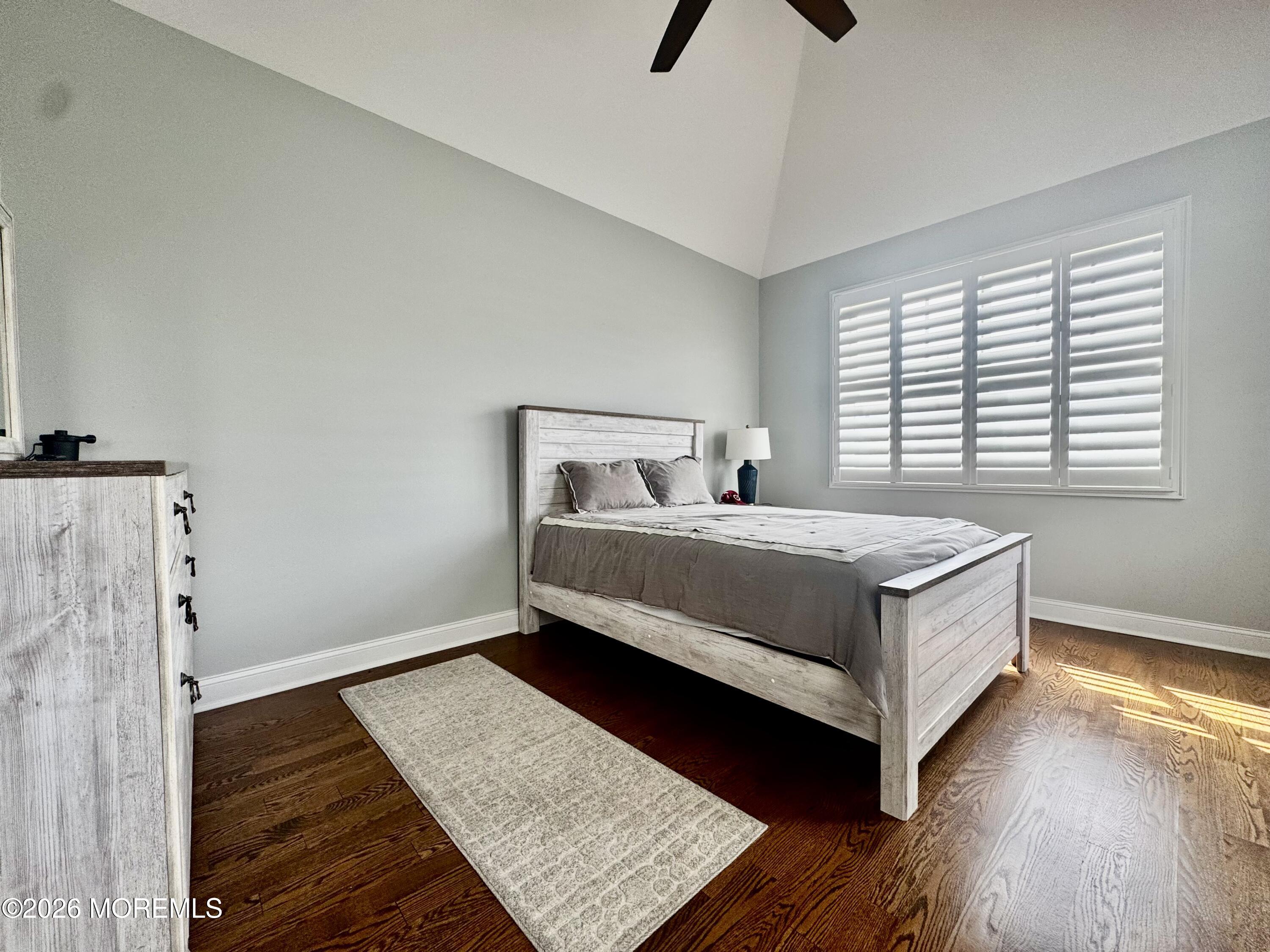 79 Pershing Boulevard Lavallette, NJ 08735 - Photo 6 of 11 a bedroom with a bed and wooden floor