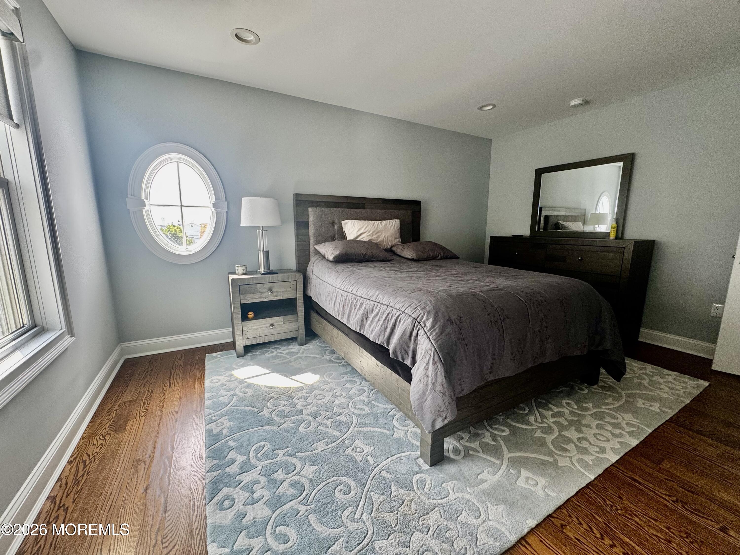 79 Pershing Boulevard Lavallette, NJ 08735 - Photo 7 of 11 a bedroom with a bed and a mirror on dresser