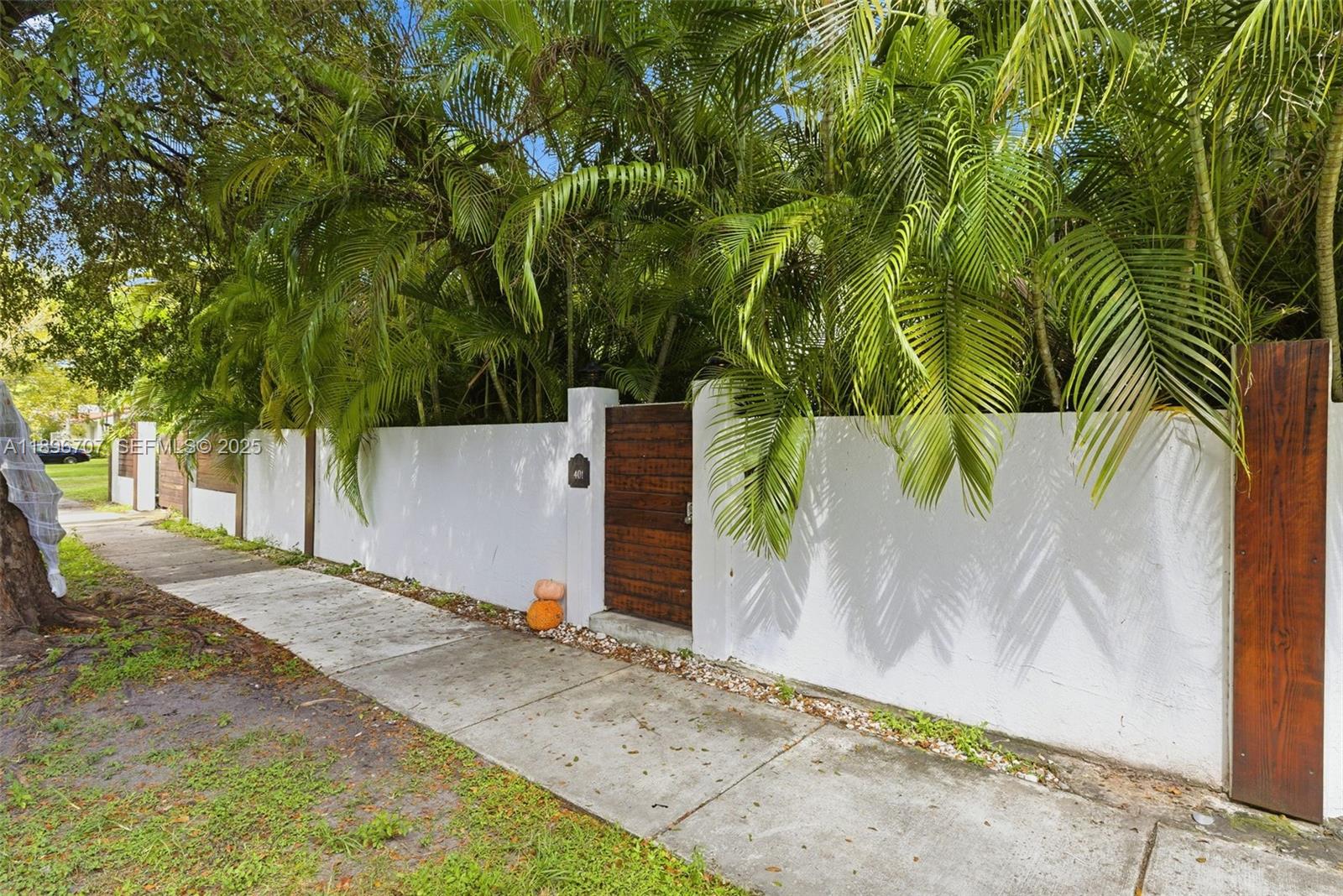 401 Southwest 28th Road Miami, FL 33129 - Photo 23 of 45 a backyard of a house with a tree and fence