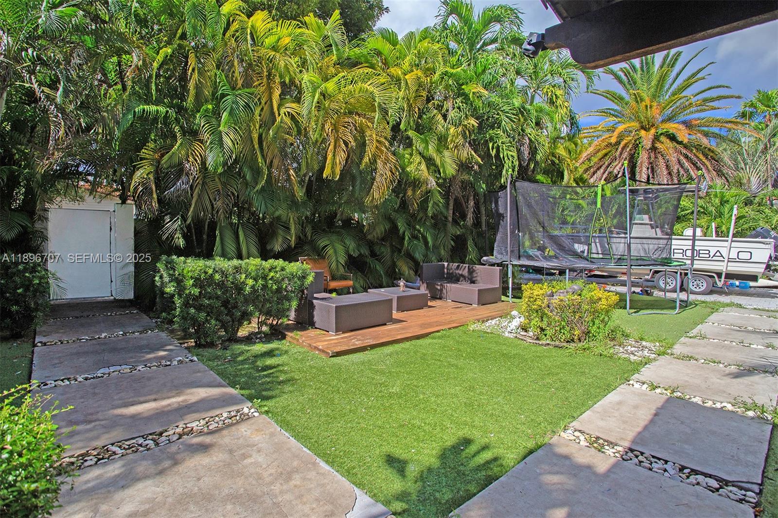 401 Southwest 28th Road Miami, FL 33129 - Photo 30 of 45 a view of a swimming pool with lawn chairs under an umbrella