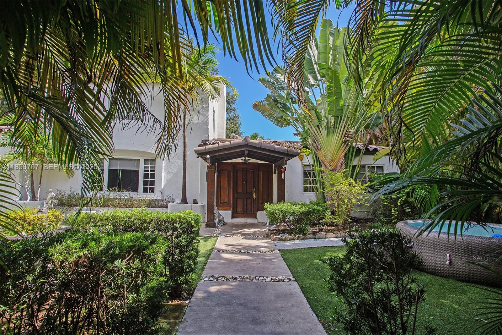 401 Southwest 28th Road Miami, FL 33129 - Photo 3 of 45 a front view of a house with a garden