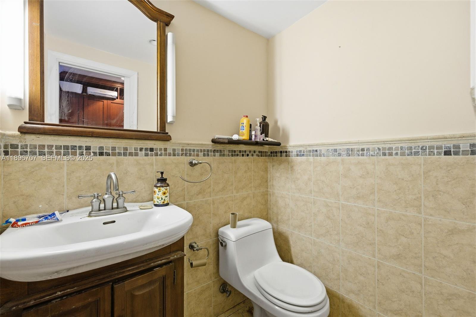 401 Southwest 28th Road Miami, FL 33129 - Photo 45 of 45 a bathroom with a sink mirror and toilet