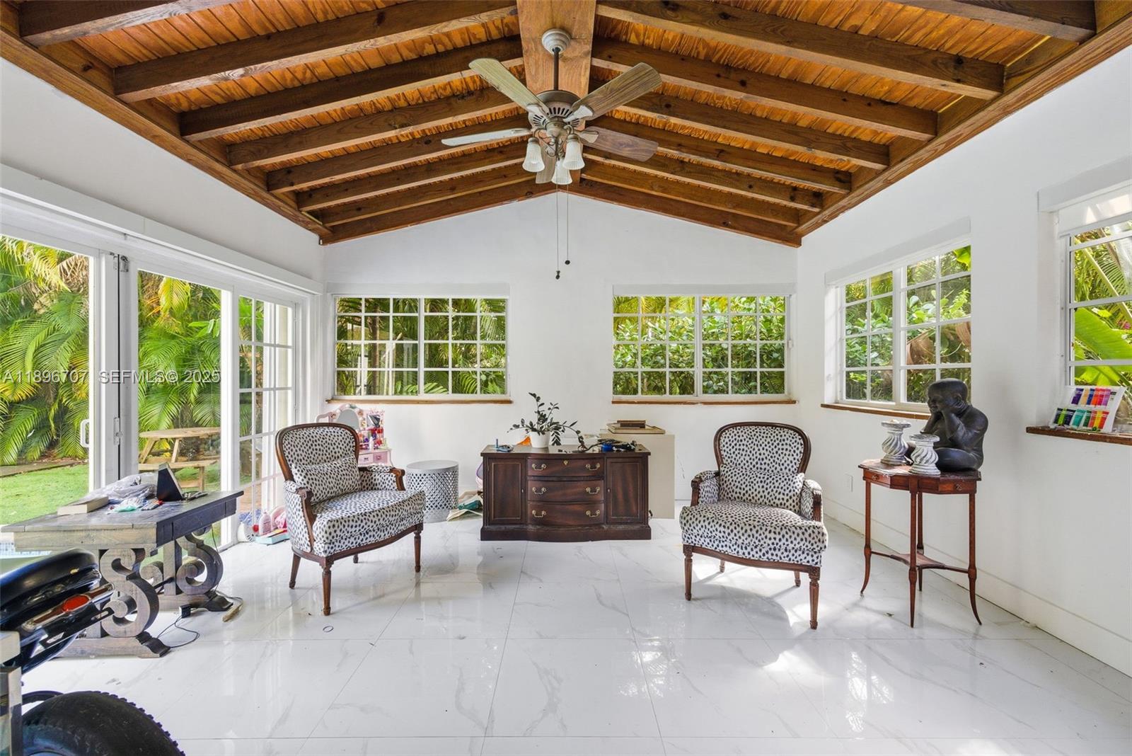 401 Southwest 28th Road Miami, FL 33129 - Photo 6 of 45 a living room with furniture and a chandelier