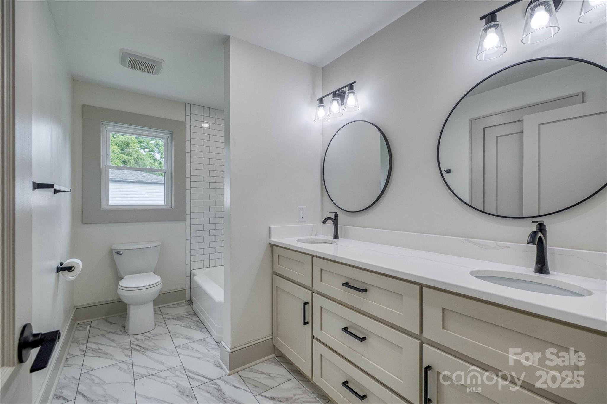 2775 Snipes Street Morganton, NC 28655 - Photo 21 of 28 a bathroom with a toilet a double vanity sink and a mirror