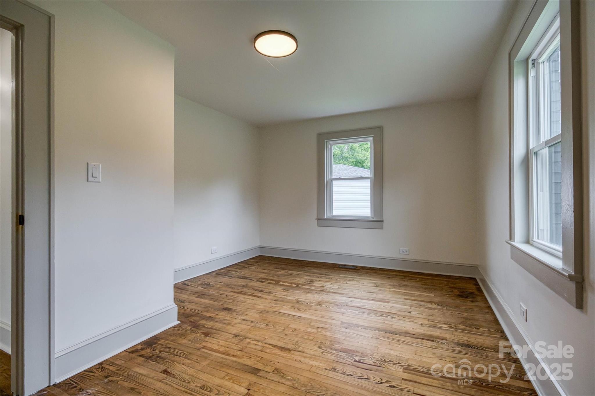 2775 Snipes Street Morganton, NC 28655 - Photo 27 of 28 an empty room with wooden floor and windows