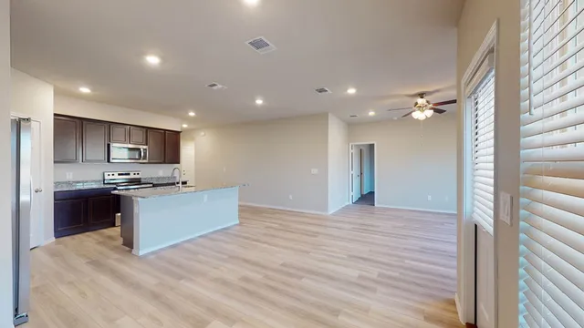 a large kitchen with kitchen island a sink stainless steel appliances and cabinets