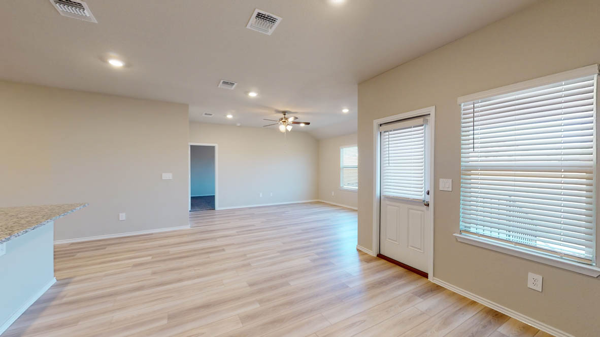140 Little Green Trail Jarrell, TX 76537 - Photo 12 of 28 a view of an empty room with wooden floor and a window