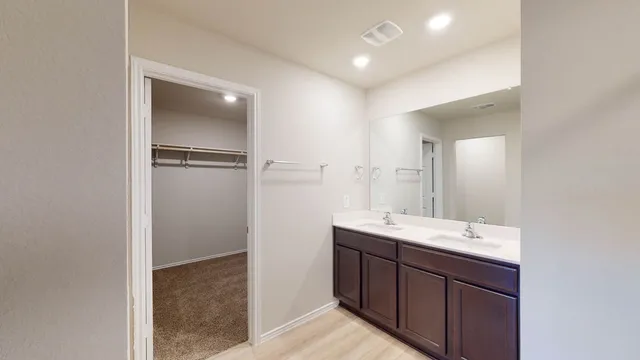 a bathroom with a double vanity sink and mirror