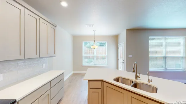 a kitchen with a sink and large window