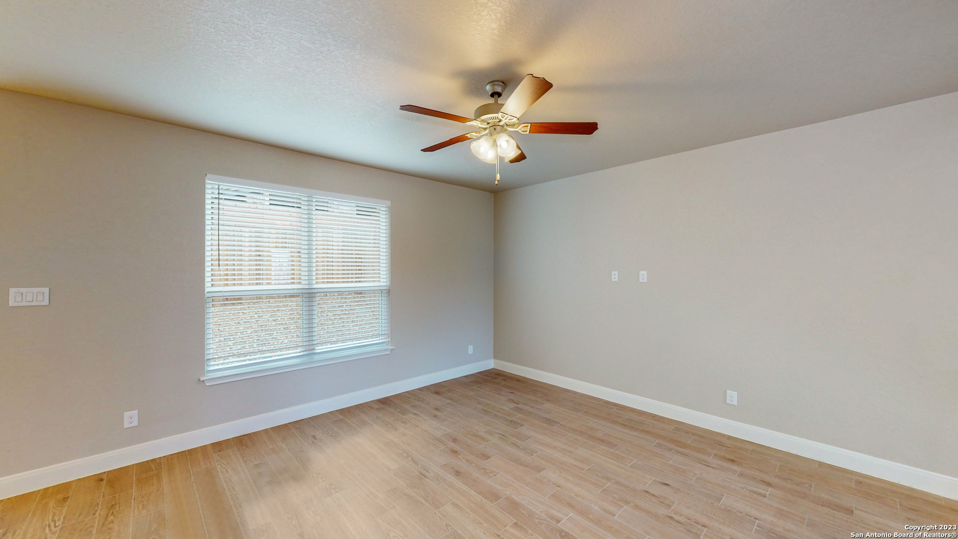 146 Magnolia Circle Boerne, TX 78006 - Photo 5 of 20 an empty room with windows and fan