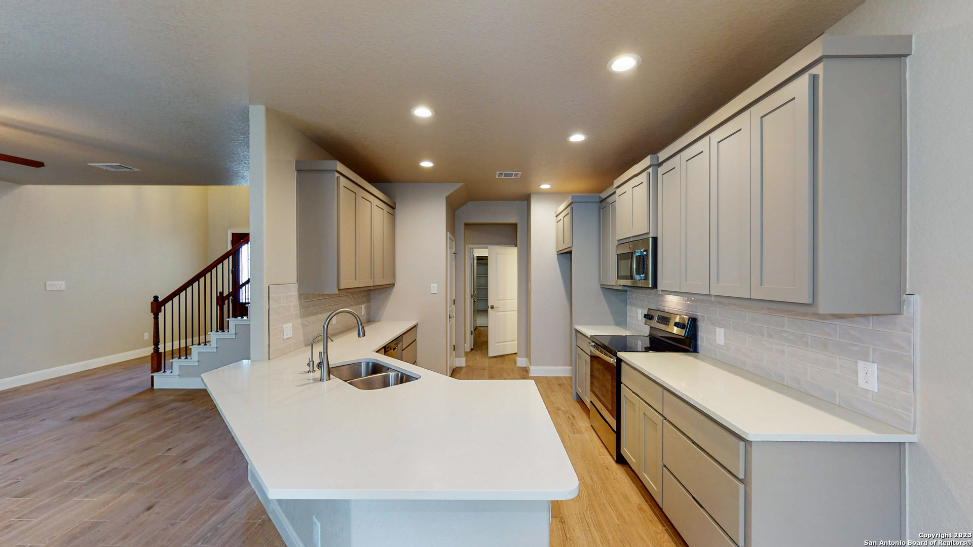 146 Magnolia Circle Boerne, TX 78006 - Photo 8 of 20 a large kitchen with stainless steel appliances a large counter top a stove a sink a refrigerator and a cabinets