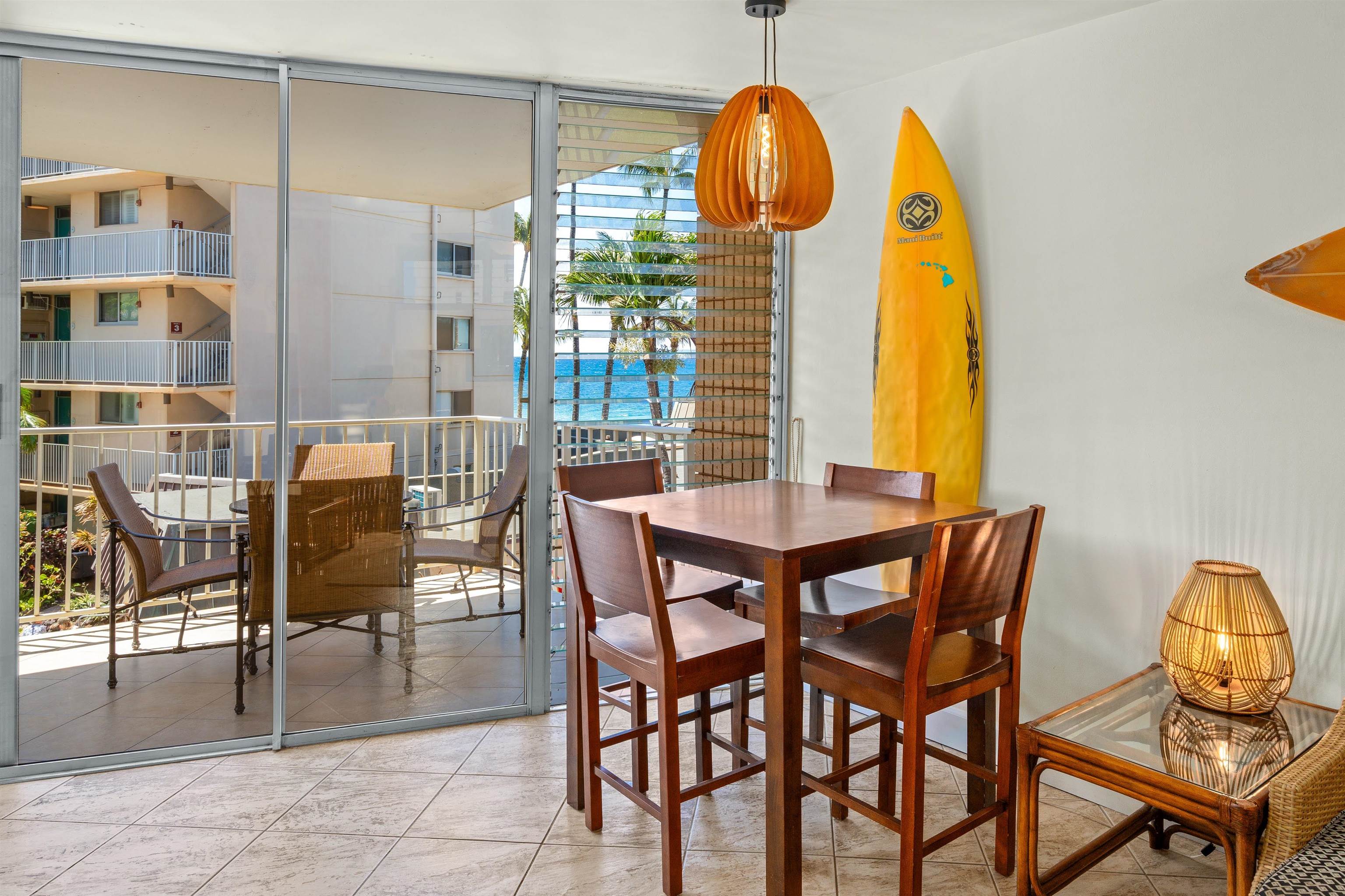 2450 South Kihei Road, Unit 301 Kihei, HI 96753 - Photo 13 of 35 a view of a dining room with furniture and chandelier