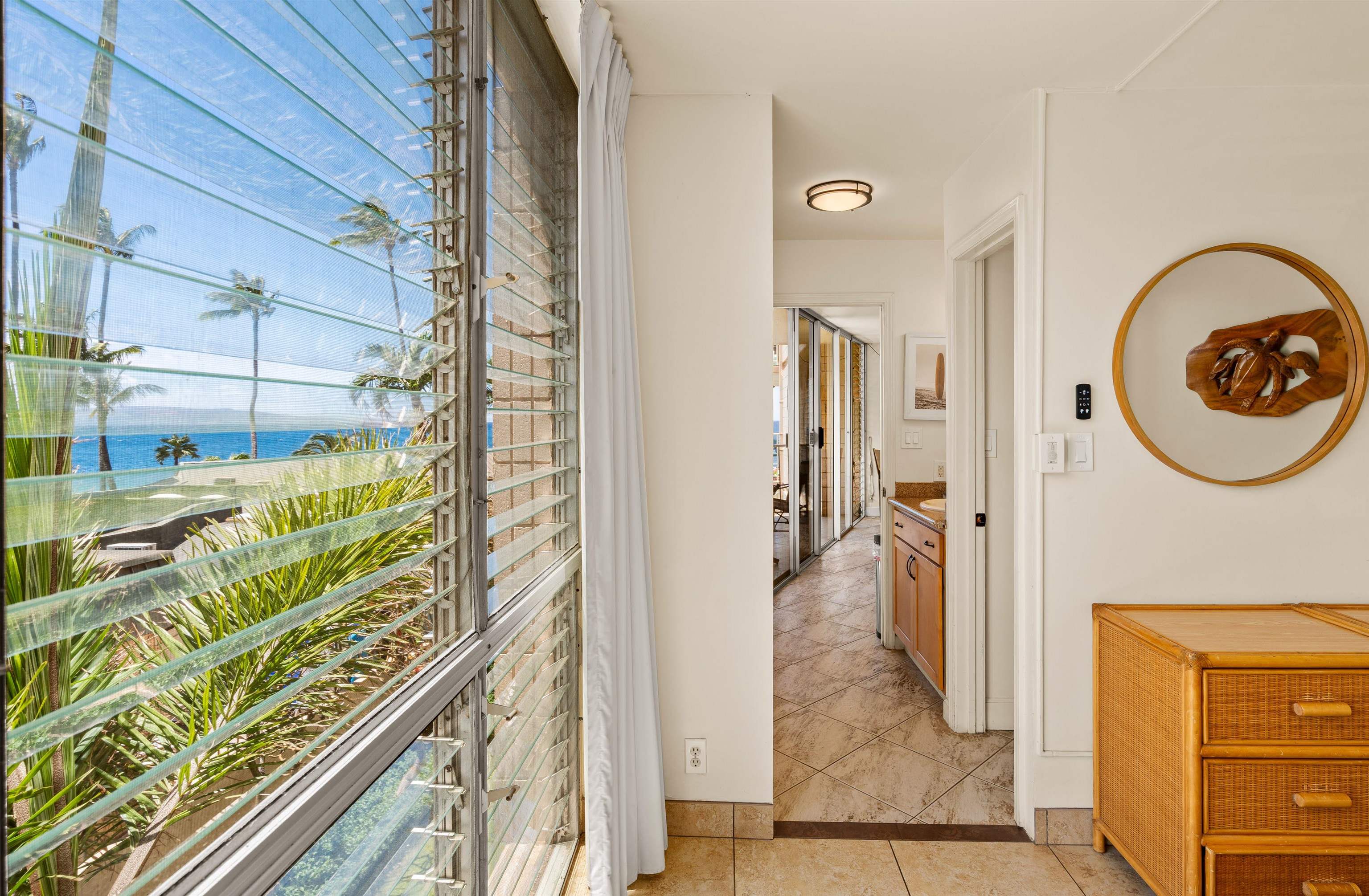 2450 South Kihei Road, Unit 301 Kihei, HI 96753 - Photo 15 of 35 a view of a hallway to a livingroom with furniture