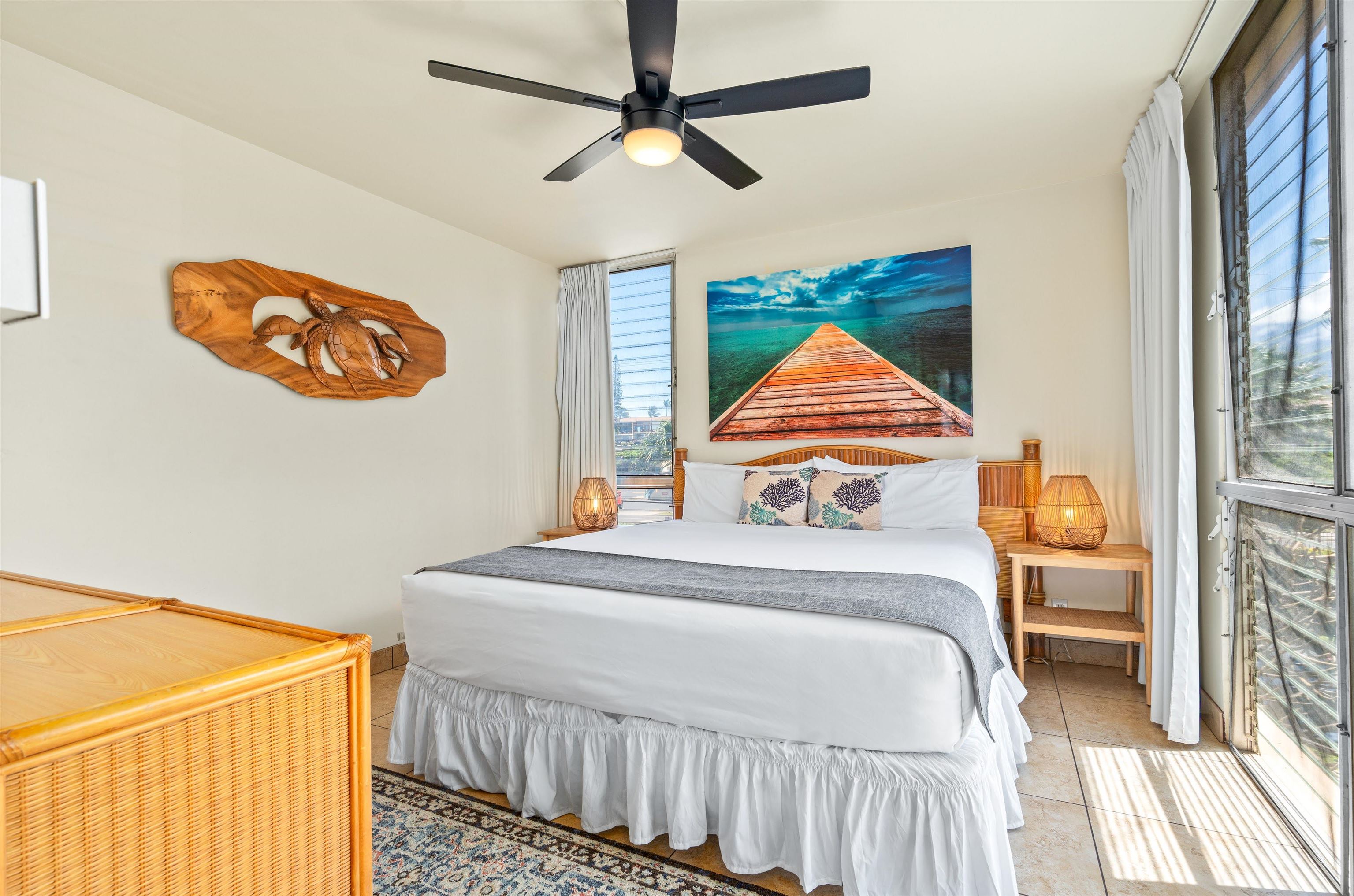 2450 South Kihei Road, Unit 301 Kihei, HI 96753 - Photo 18 of 35 a bedroom with a bed and a chandelier