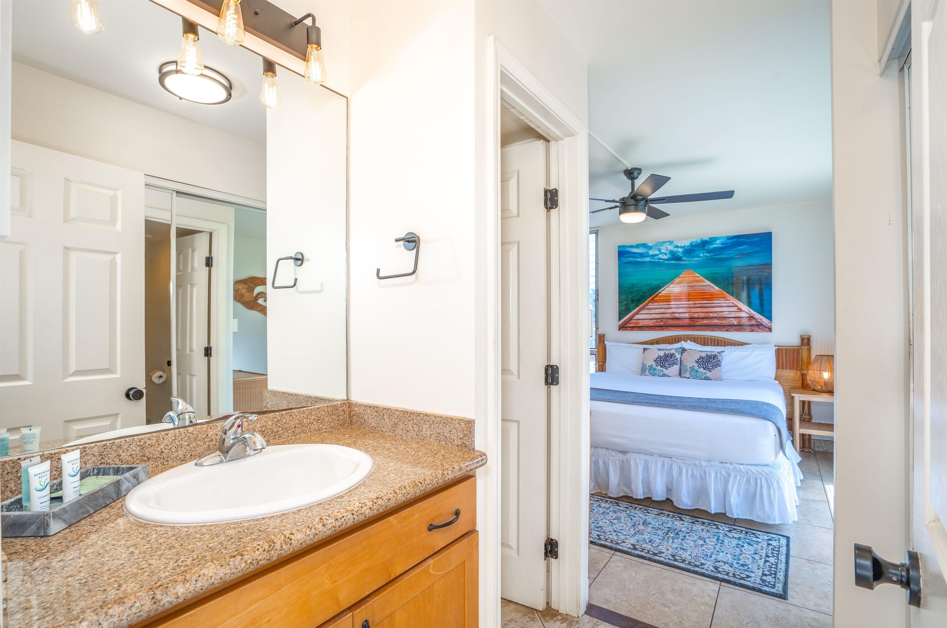 2450 South Kihei Road, Unit 301 Kihei, HI 96753 - Photo 19 of 35 a bathroom with a granite countertop sink and a mirror