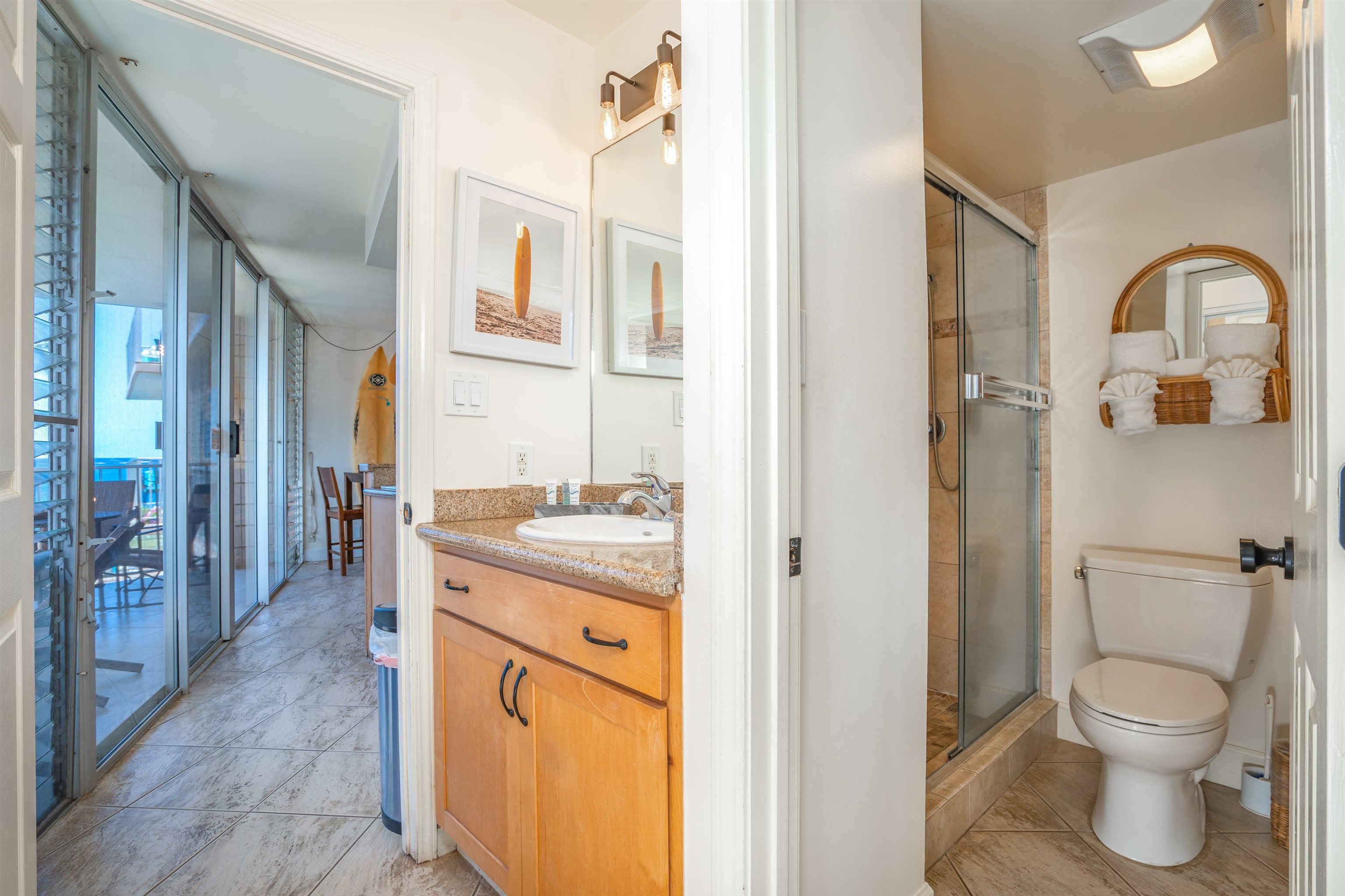 2450 South Kihei Road, Unit 301 Kihei, HI 96753 - Photo 20 of 35 a bathroom with a granite countertop toilet a sink and a mirror