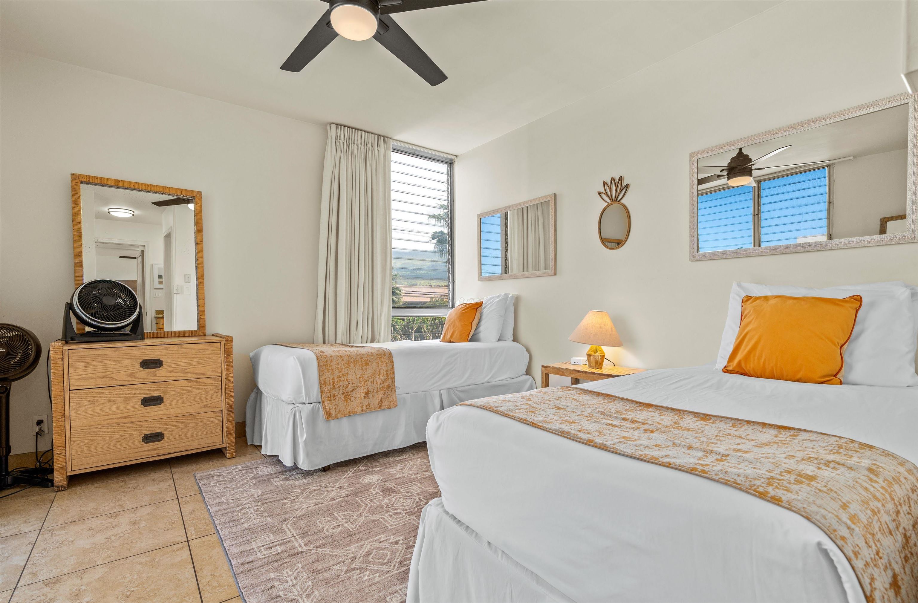 2450 South Kihei Road, Unit 301 Kihei, HI 96753 - Photo 22 of 35 a bedroom with two beds and a dresser