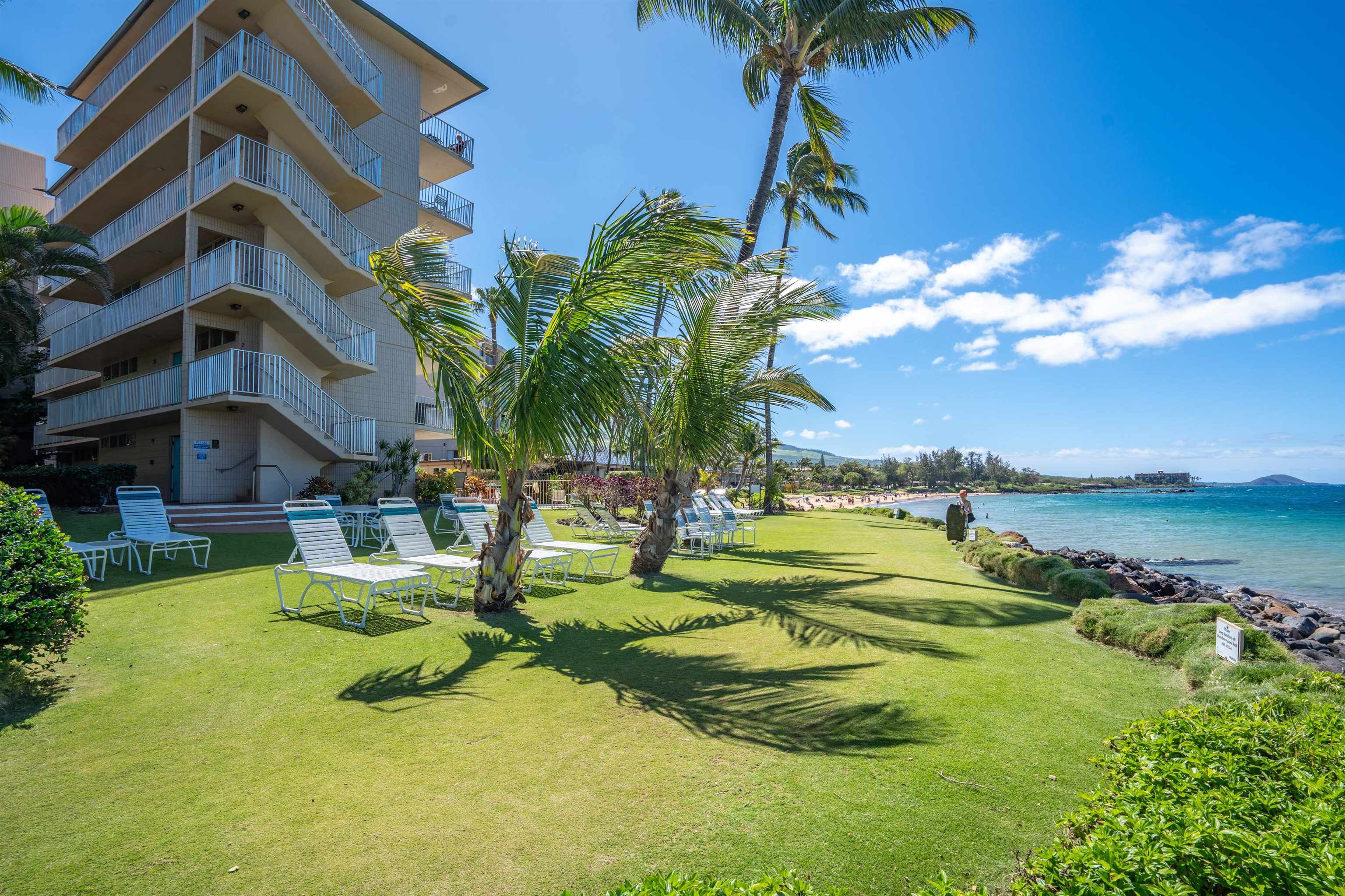 2450 South Kihei Road, Unit 301 Kihei, HI 96753 - Photo 28 of 35 a view of a house with swimming pool and a yard