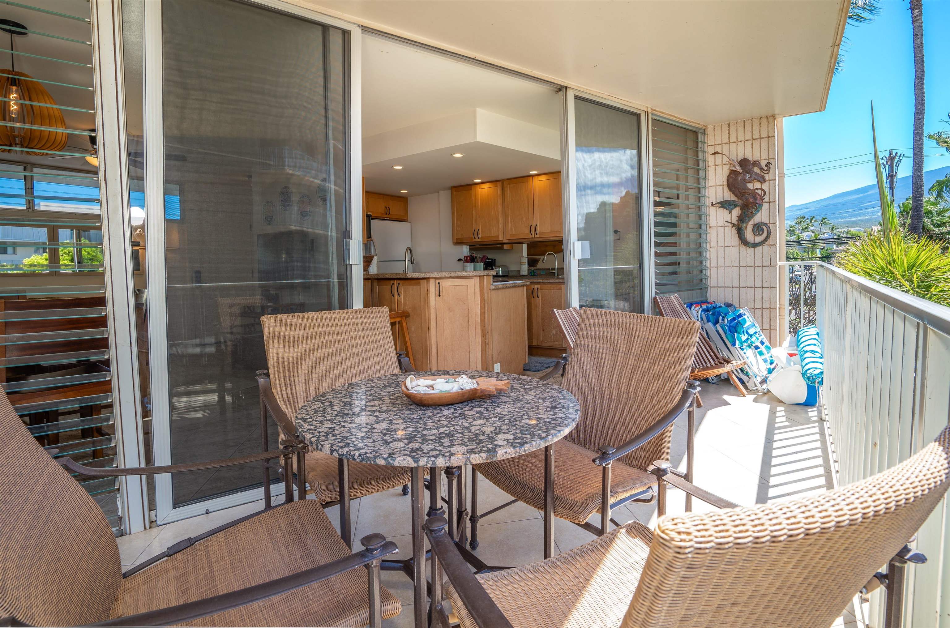 2450 South Kihei Road, Unit 301 Kihei, HI 96753 - Photo 3 of 35 a outdoor dining space with furniture and a potted plant
