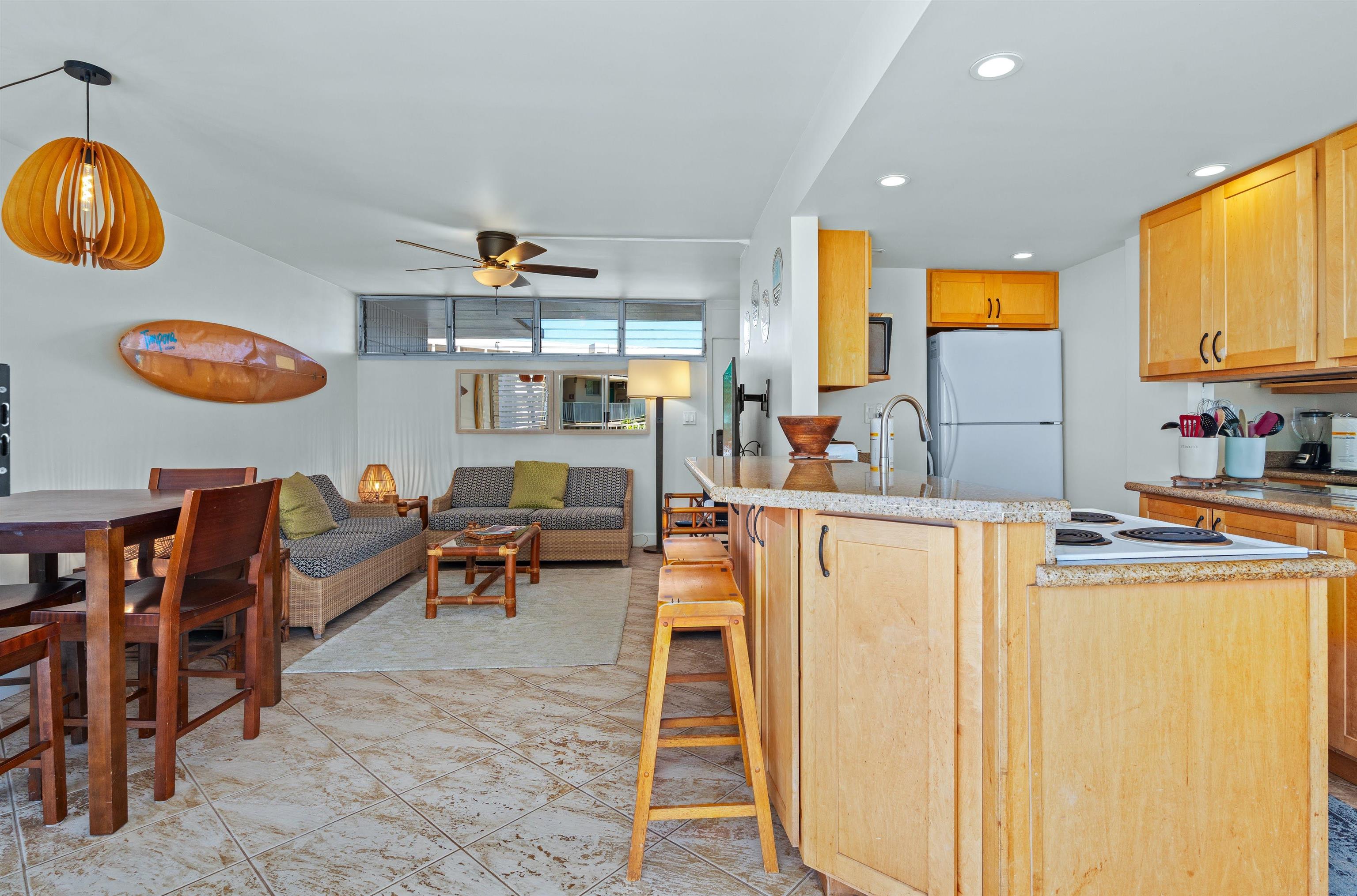 2450 South Kihei Road, Unit 301 Kihei, HI 96753 - Photo 7 of 35 a living room with furniture and a table